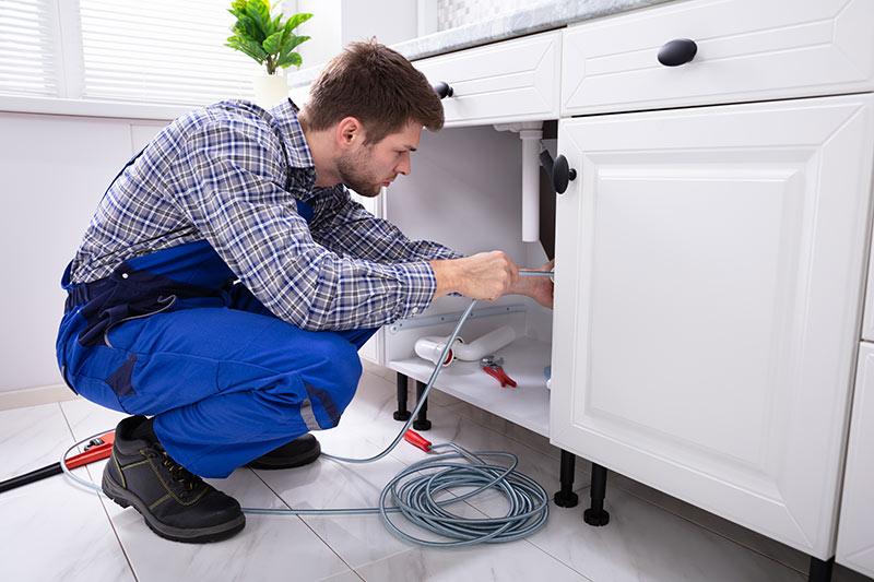 plumber installing new sink | Pinpoint Plumbing In Anaheim, CA